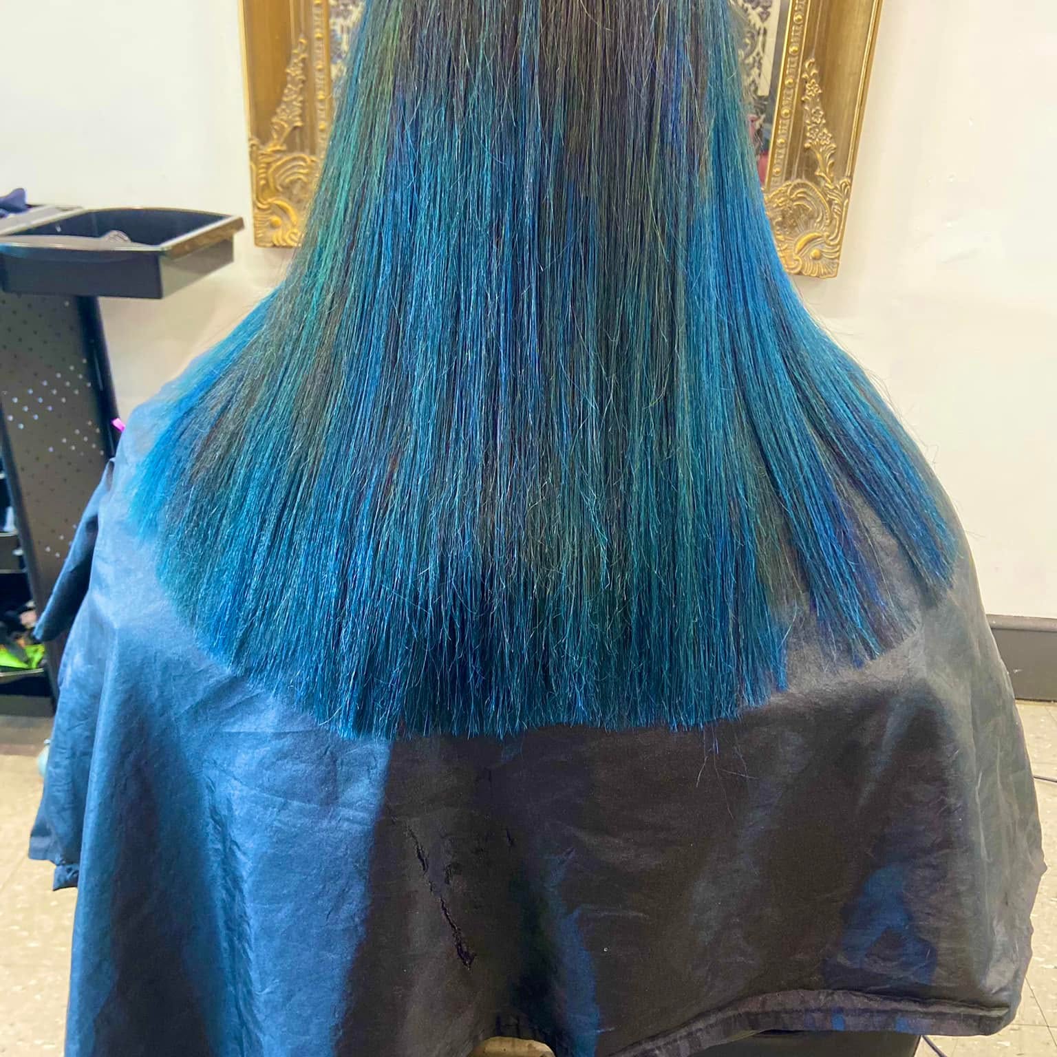 Long straight hair coloured in deep teal and blue tones
